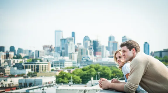 Happy couple outside their high-rise new apartment
